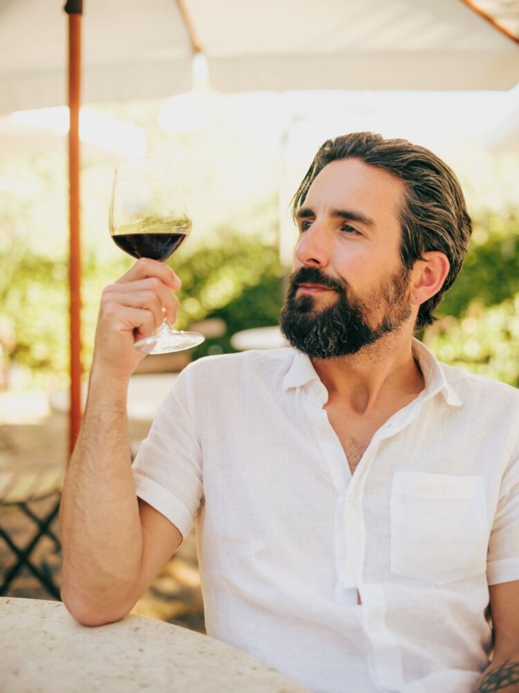 classy Italian man enjoying a glass of wine