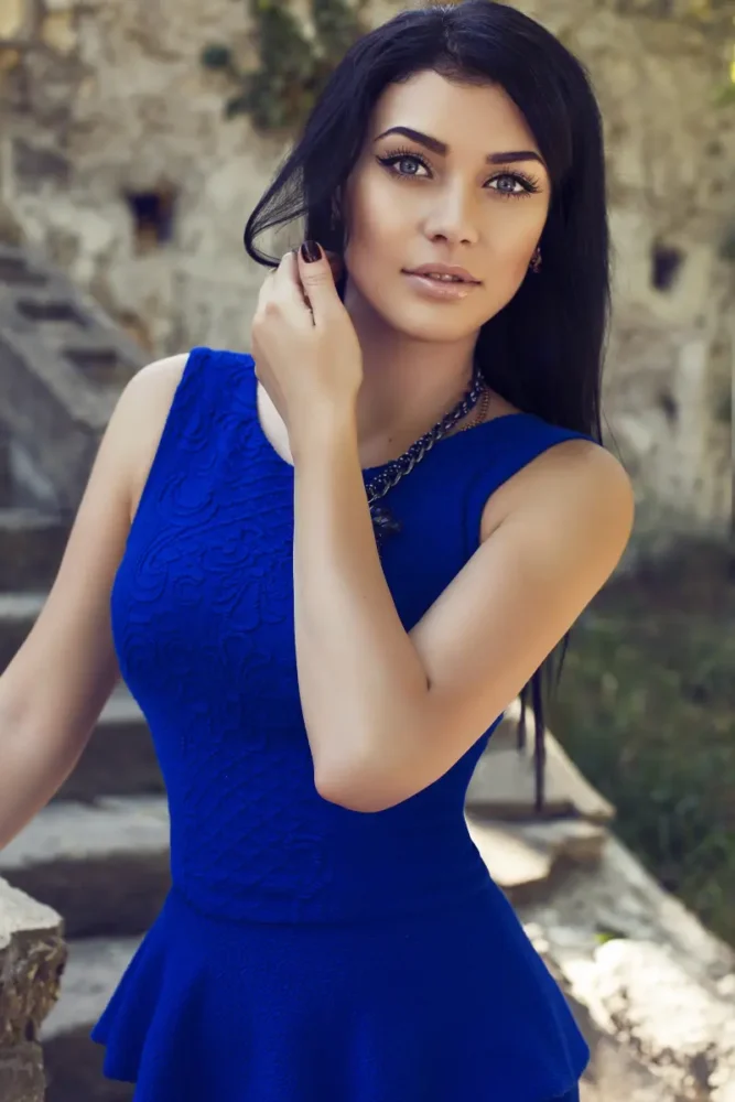 fit brunette Serbian woman wearing blue dress