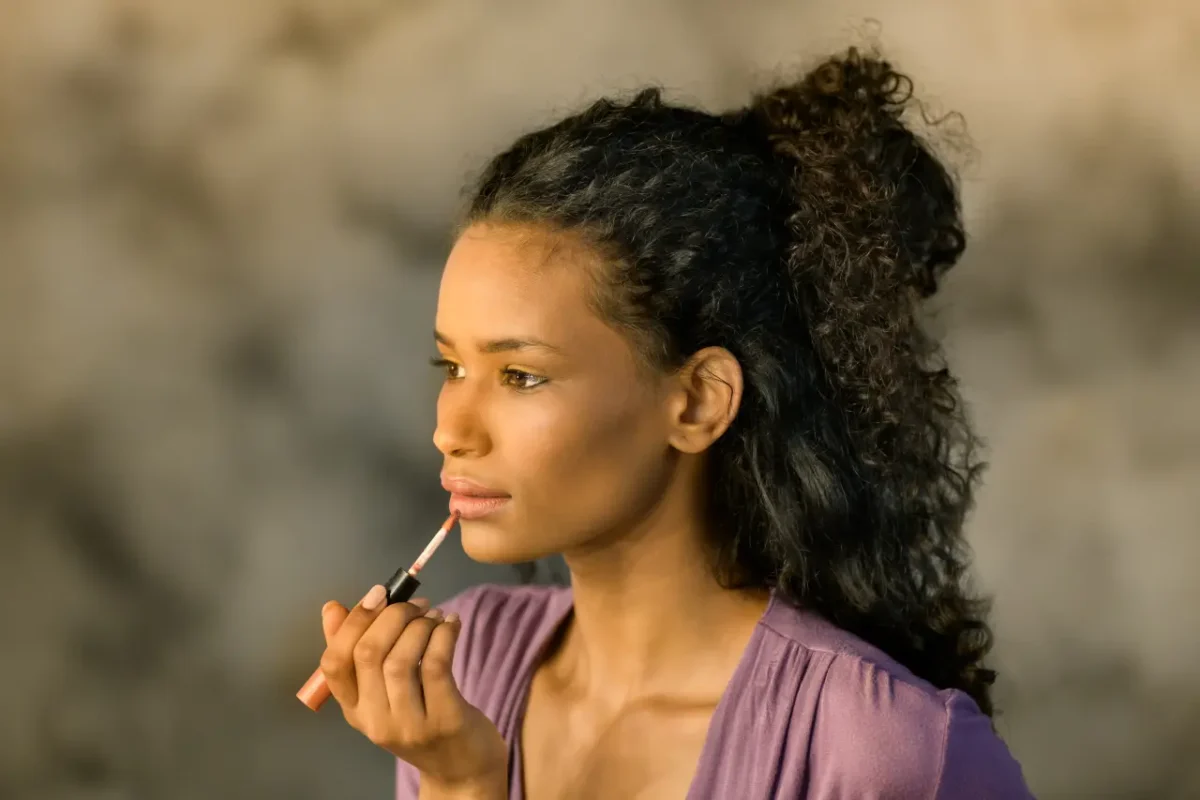 beautiful girl from the Dominican Republic applying makeup