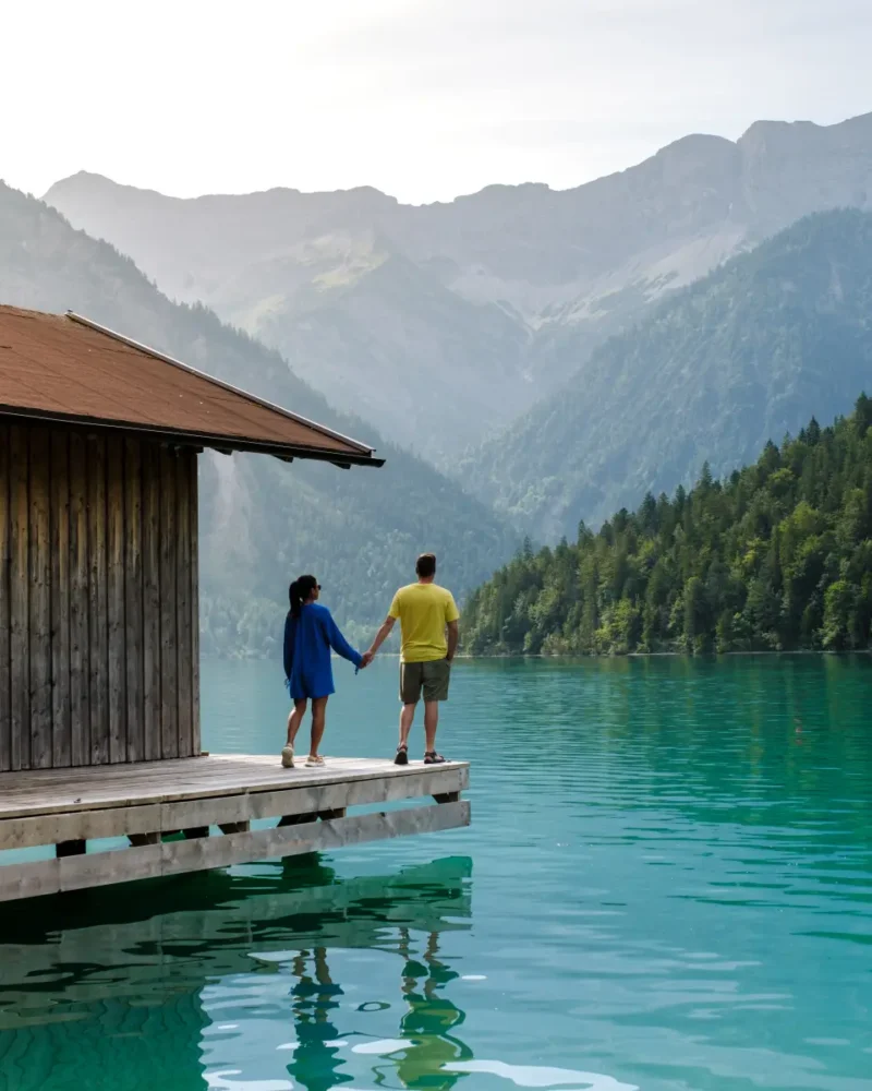 couple holding hands near lake in Austria