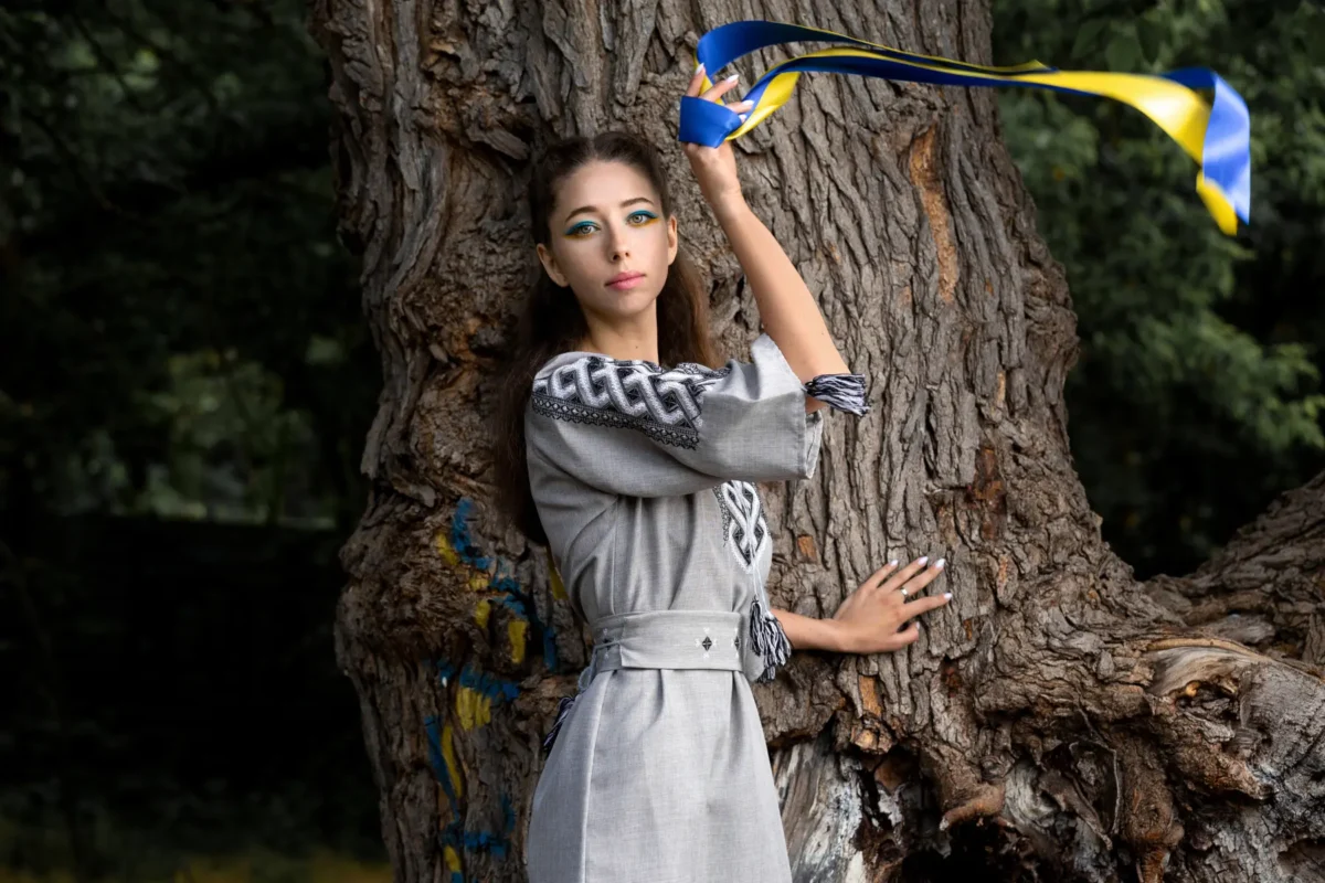 girl with Ukrainian ribbon near a tree